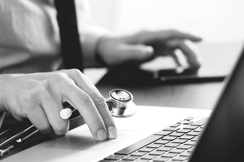 A doctor using a laptop.