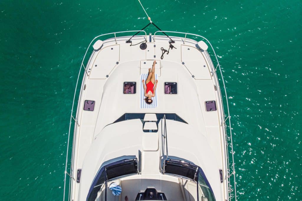 Woman lying on the deck of a catamaran.