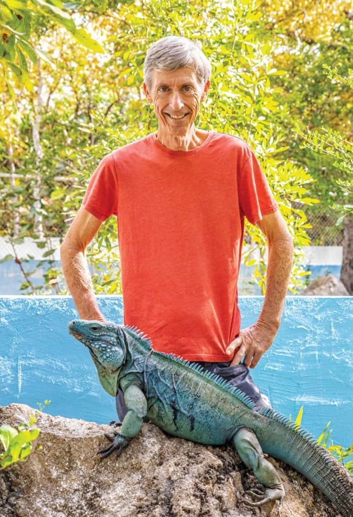 Fred Burton next to a Cayman Islands blue iguana.