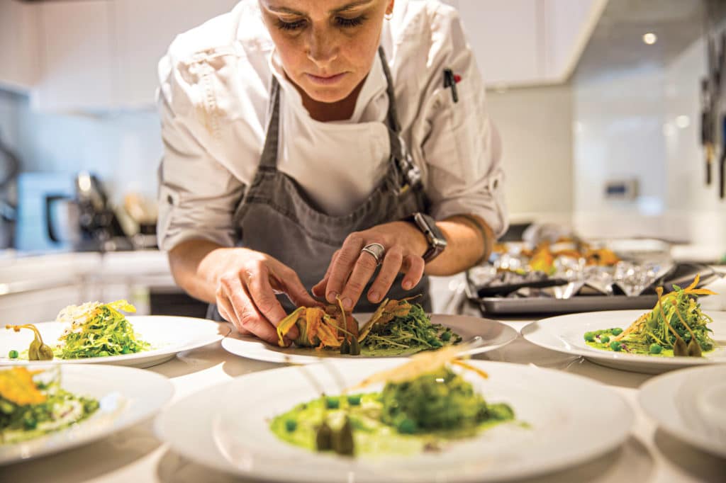 A chef making food on a yacht.