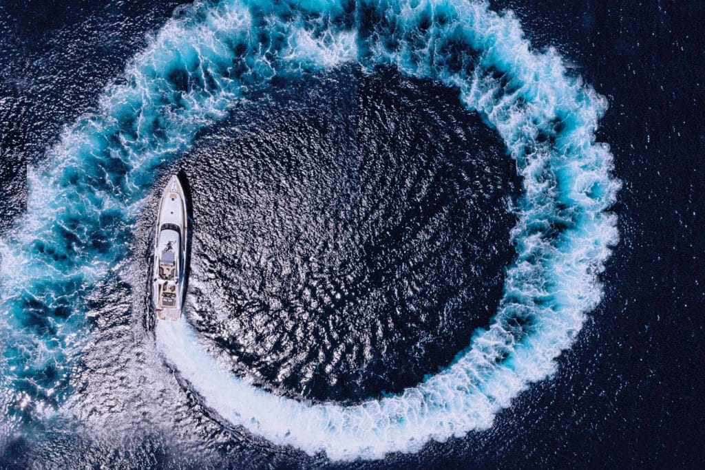 A yacht steering clockwise in a circle.