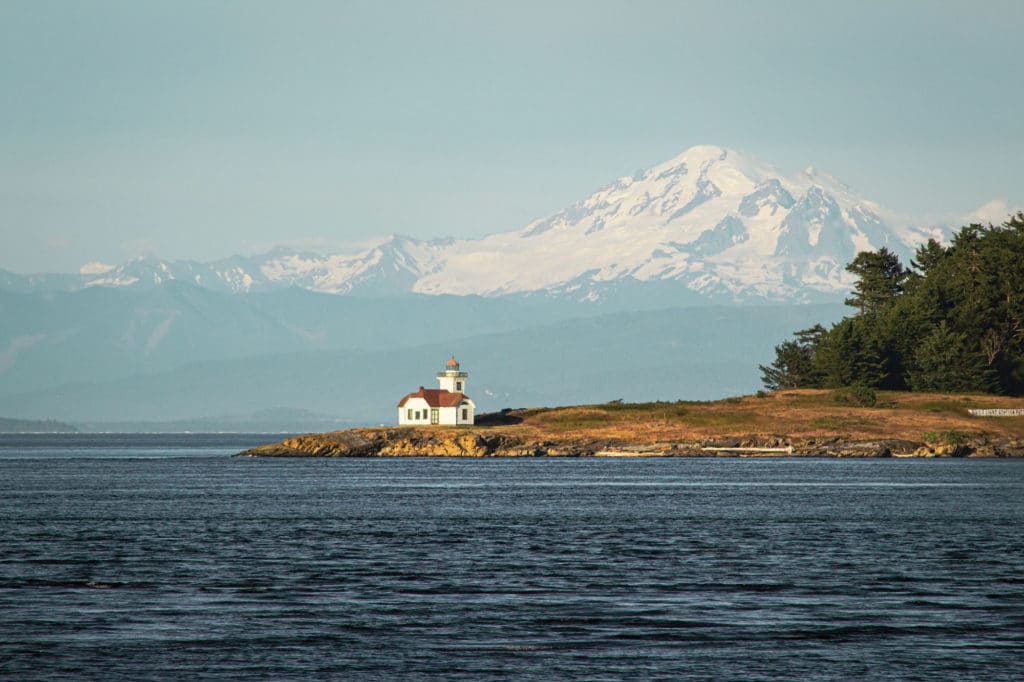 Lighthouse next to mountains