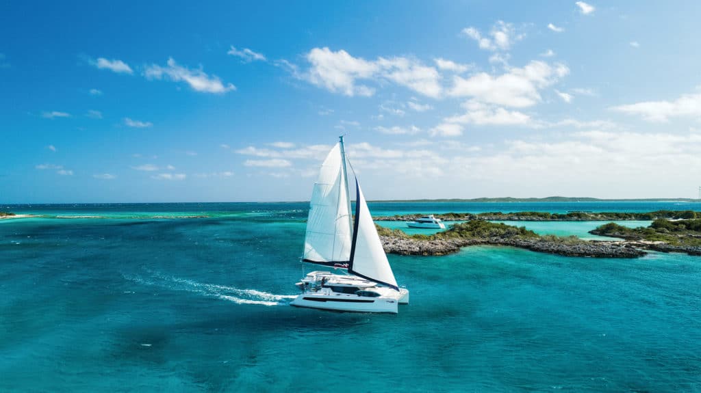 sailboat cruising on turquoise water