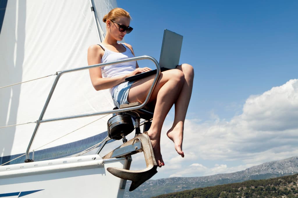 woman using a laptop on a boat