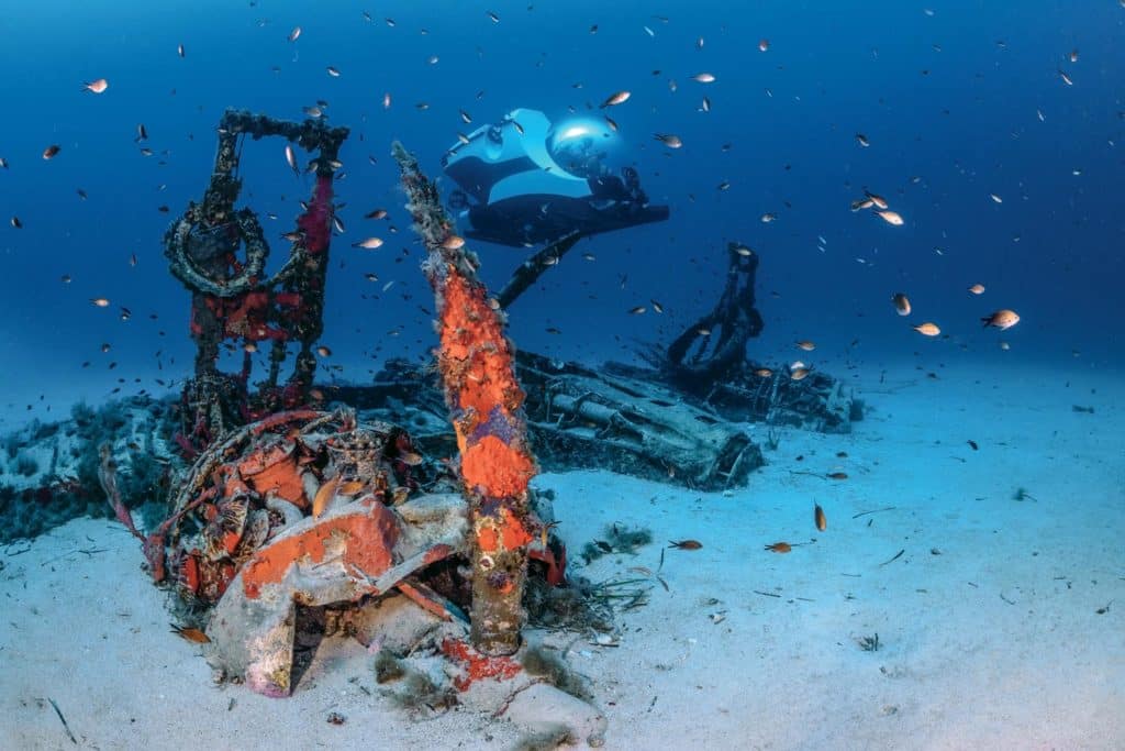 submarine next to underwater airplane wreckage