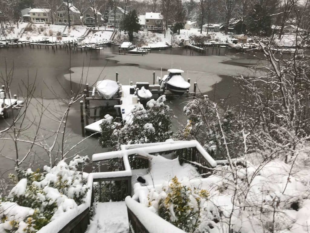 Aerial view of a boat dock covered with snow and ice.
