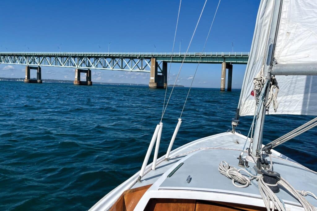 Sailboat heading towards a bridge