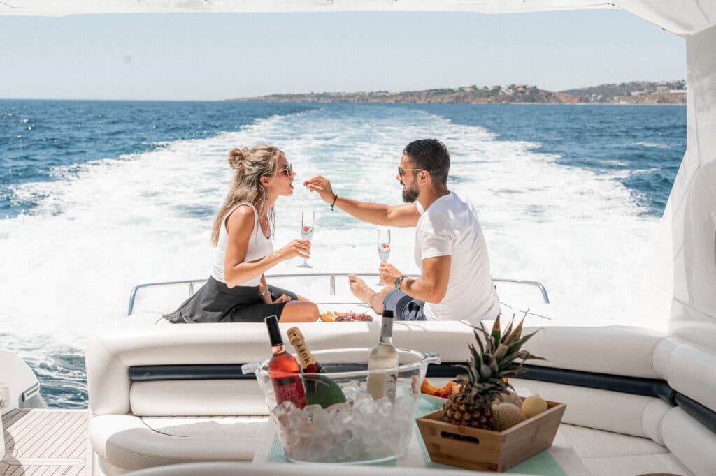 A couple sitting on the back of a boat