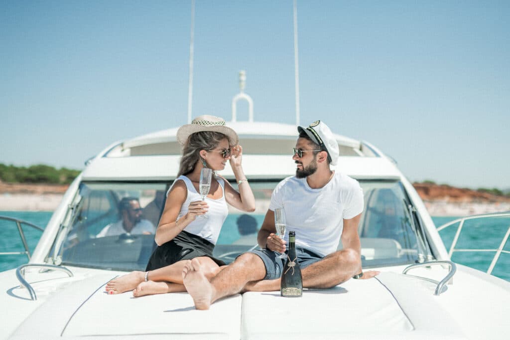 A couple sitting on the front of a boat
