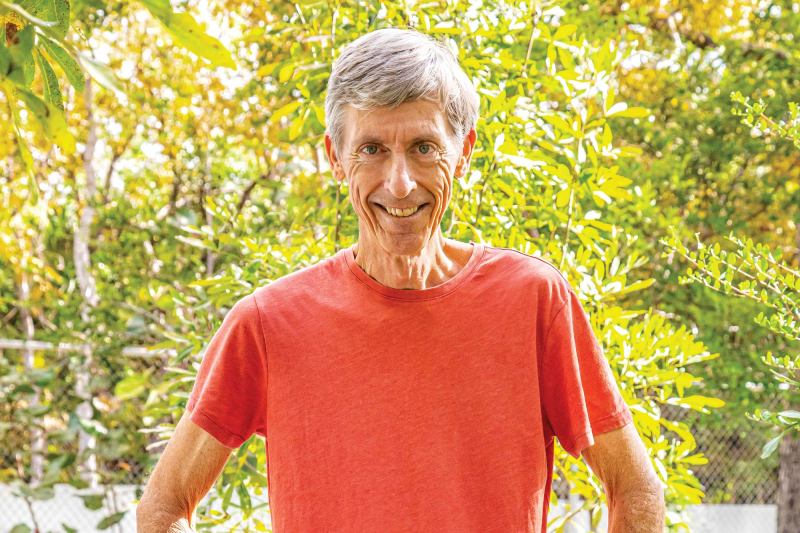 Fred Burton next to a Cayman Islands blue iguana.