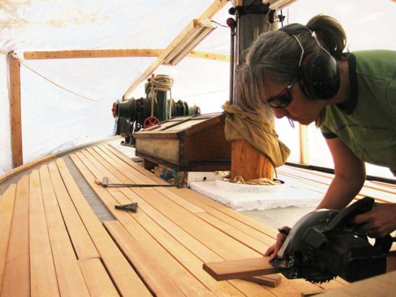 Winter projects The author works under the winter cover to replace the foredeck, winter 2011.