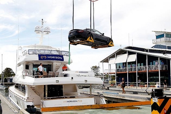 Maserati on Horizon P110 trideck A $400,000 Maserati Gran Turismo MC Stradale is lowered onto the upper deck of a Horizon P110 trideck motoryacht.