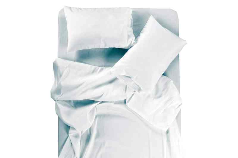 Bed covered with bed spreads and soft pillow.