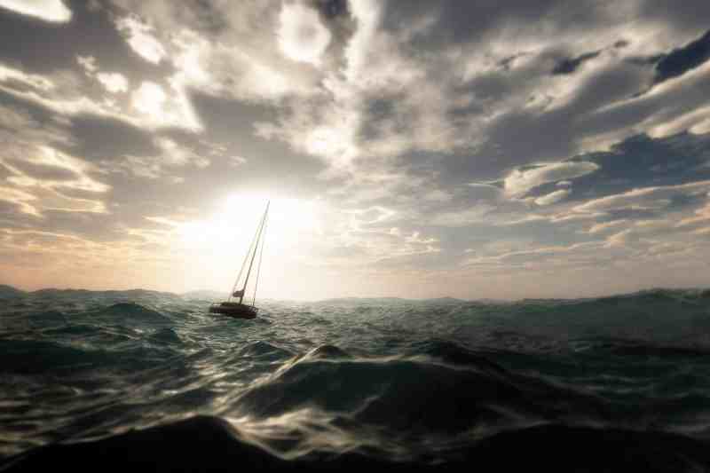 Lost sailing boat in wild stormy ocean. Cloudy sky. Lost sailing boat in wild stormy ocean. Cloudy sky.