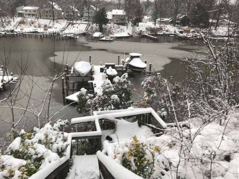 Snowy-McMenamin-Dock Aerial view of a boat dock covered with snow and ice.