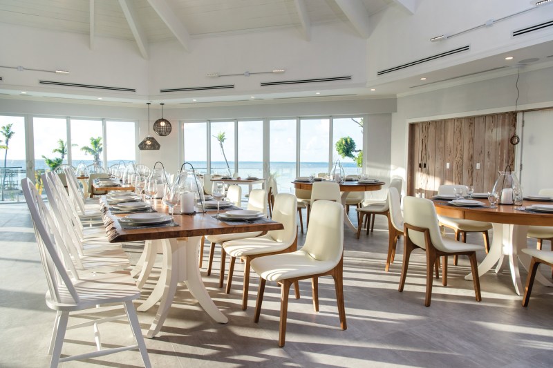 Bright dining room with a long wooden table set